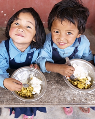 おいしそうに給食を頬張る子どもたち。